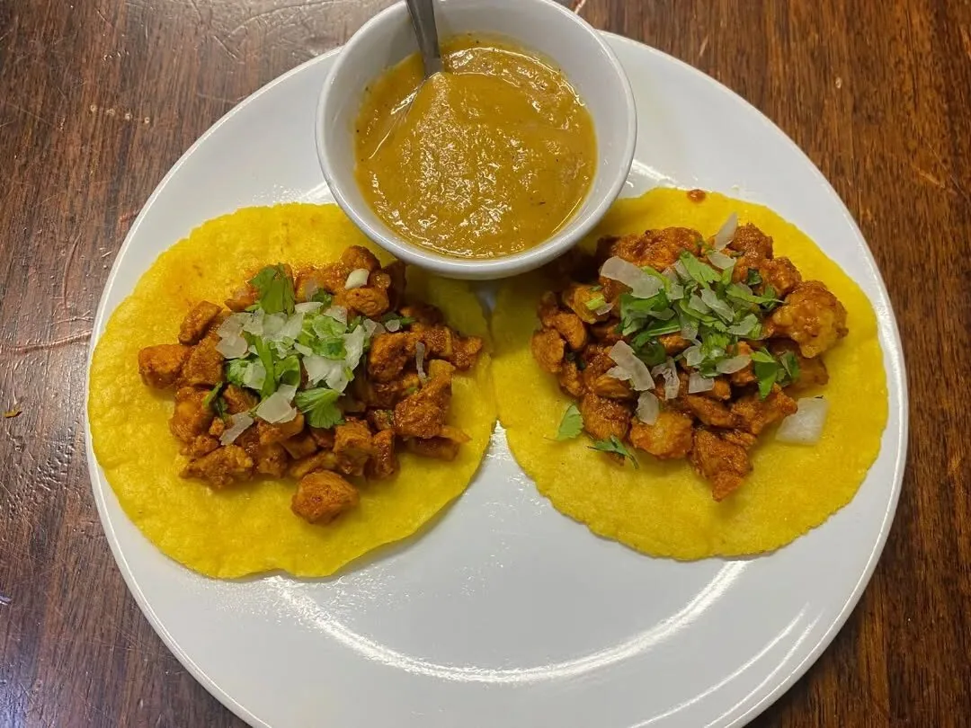 Tacos al pastor with salsa at Guacamoles