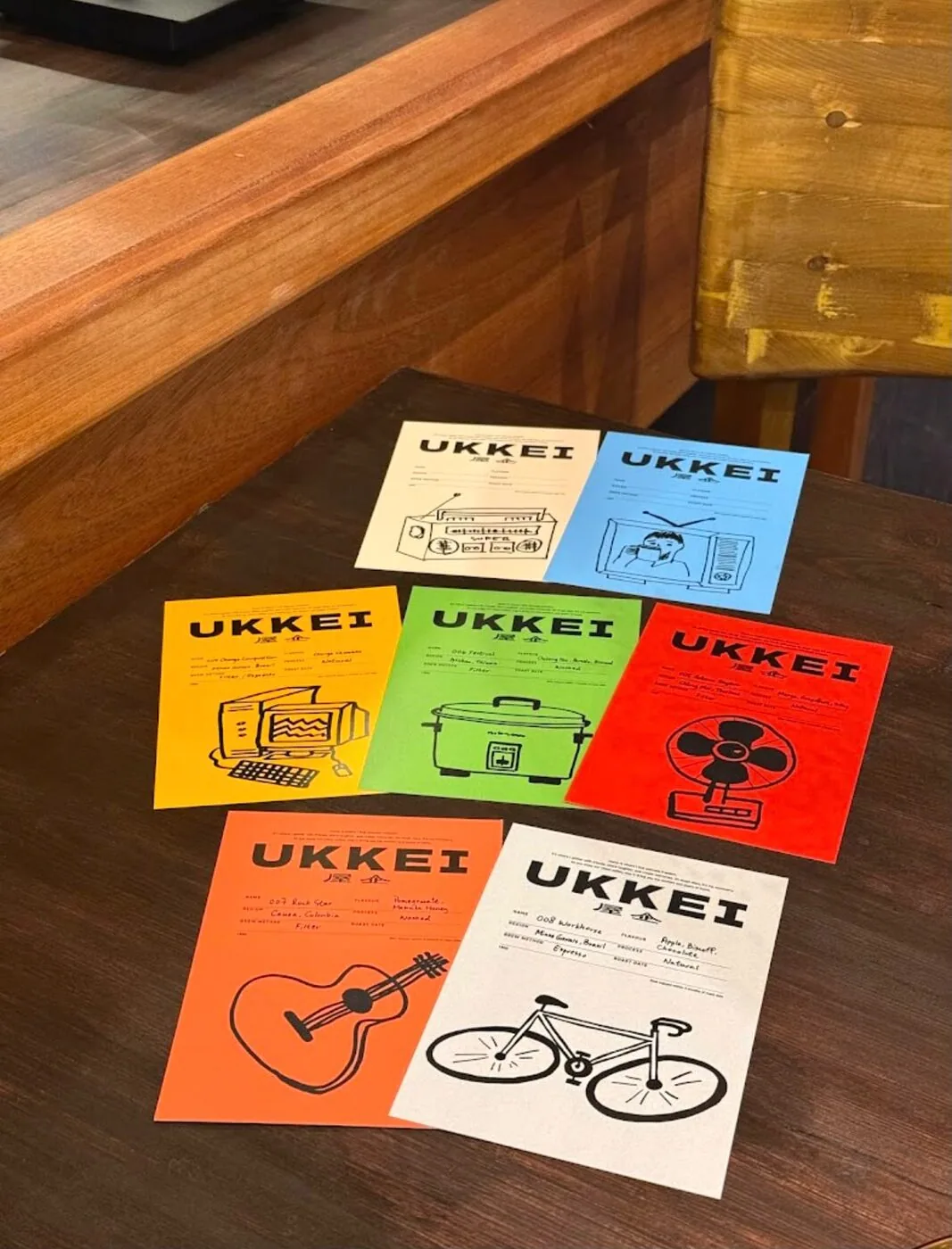 Ukkei Coffee's hand-drawn tasting cards spread across the counter